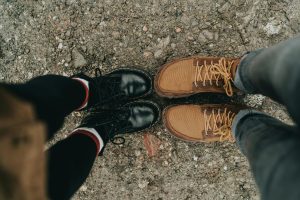 Guys wearing black boots and brown shoes 
