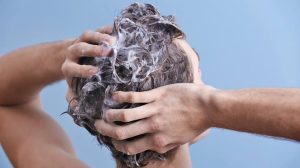 Man moisturizing hair