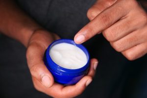 Hand holding lip balm
